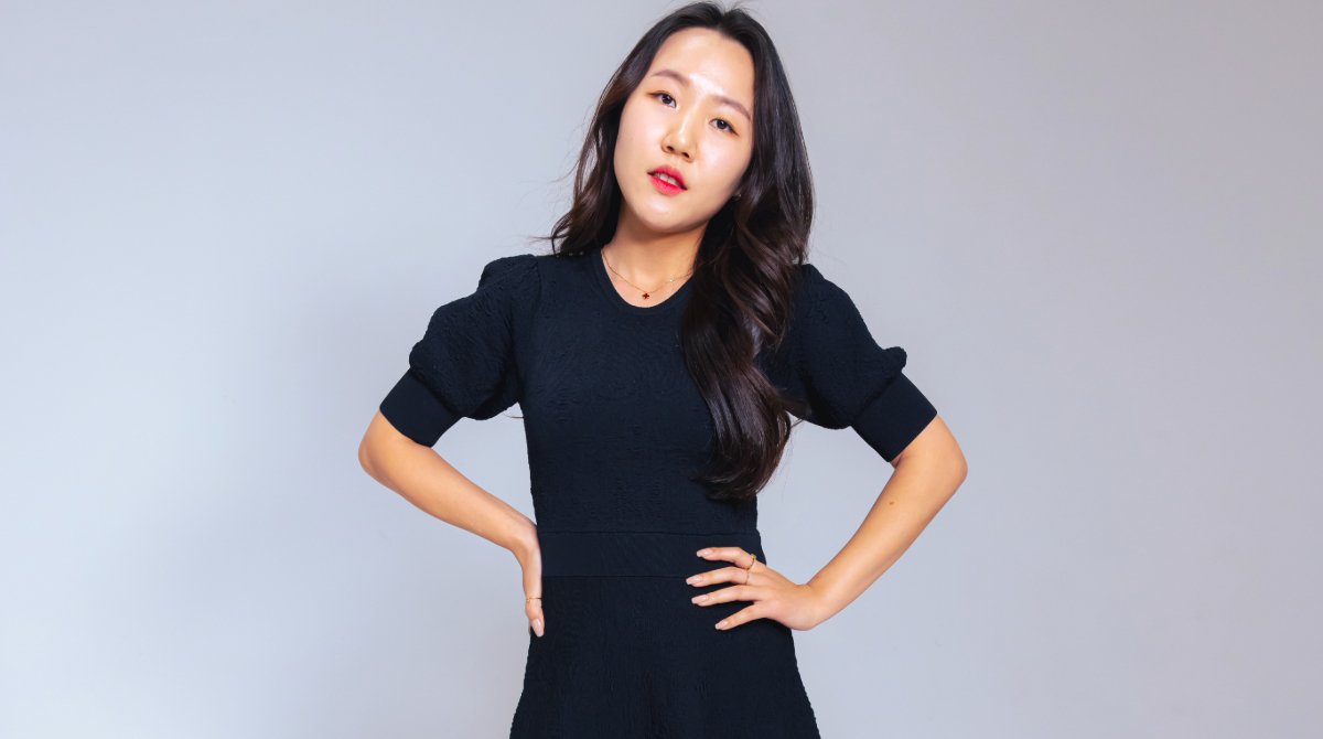 Businesswoman stand confidently and looks straight ahead.