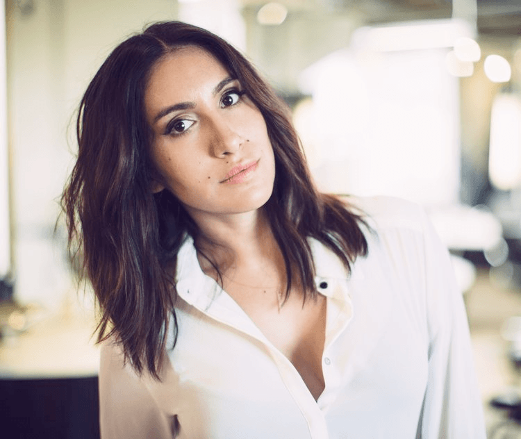 A headshot of Jen Atkin. She leans slightly to one side, her dark hair falling over her shoulders.
