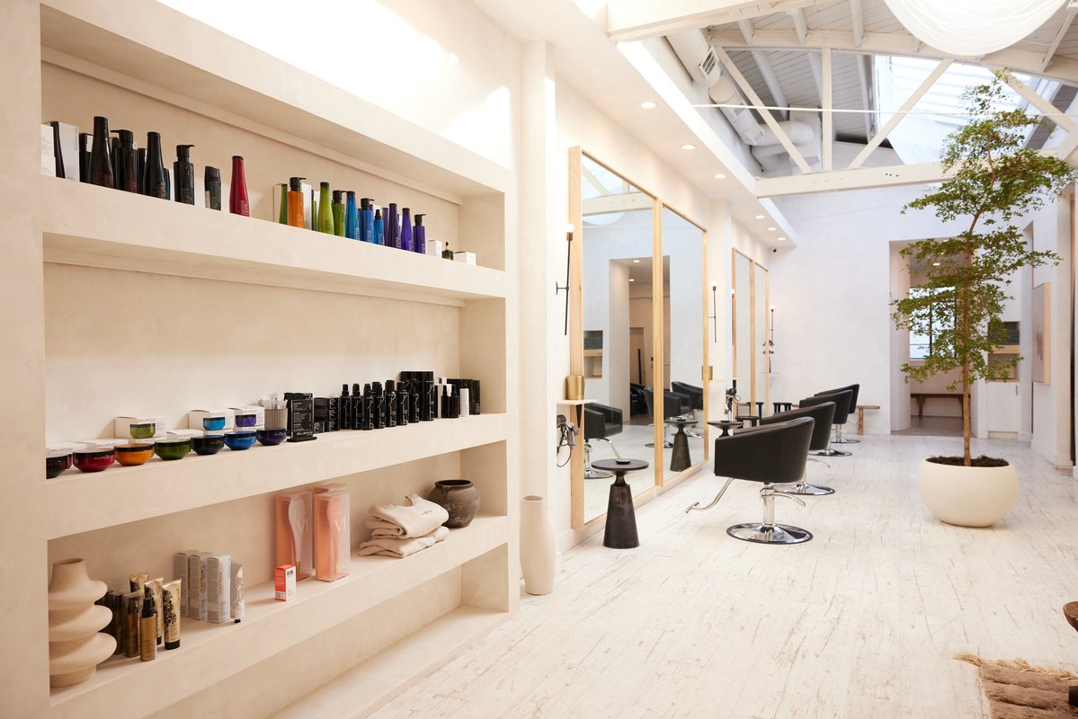 Interior view of a salon, showing the inventory shelf and salon chairs.