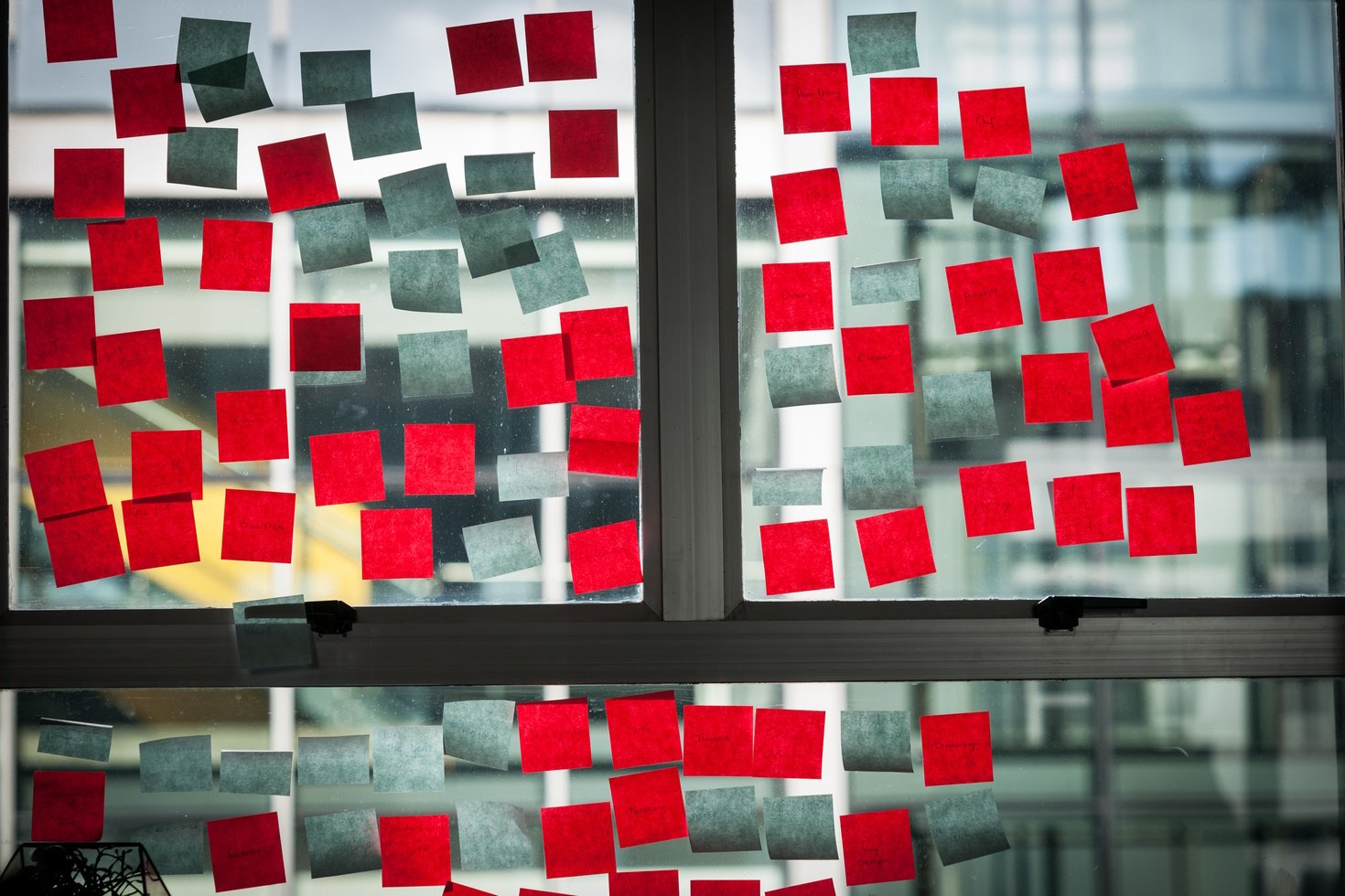 A window covered with bright red sticky notes.