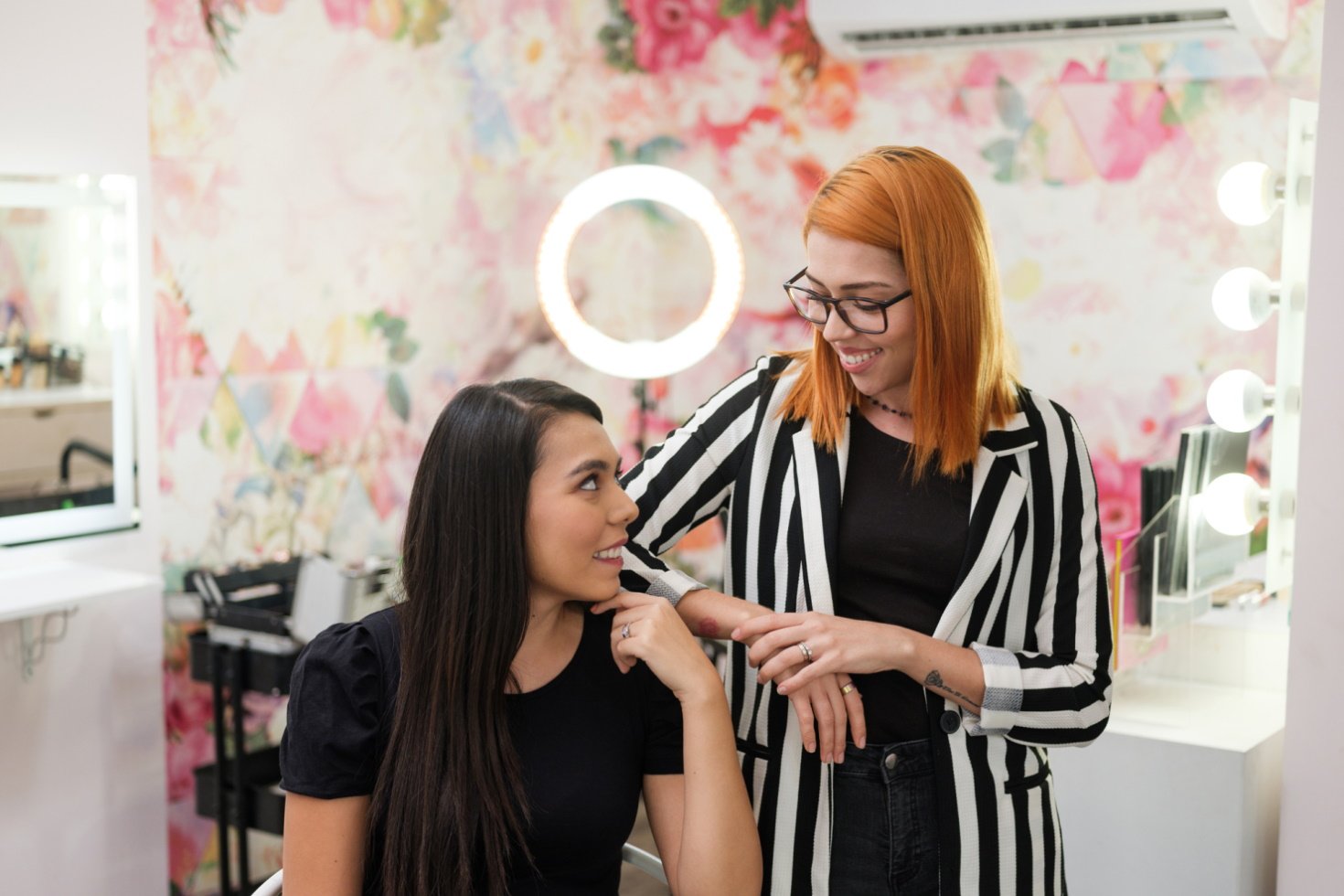 Two smiling women beauty professionals prepare for work