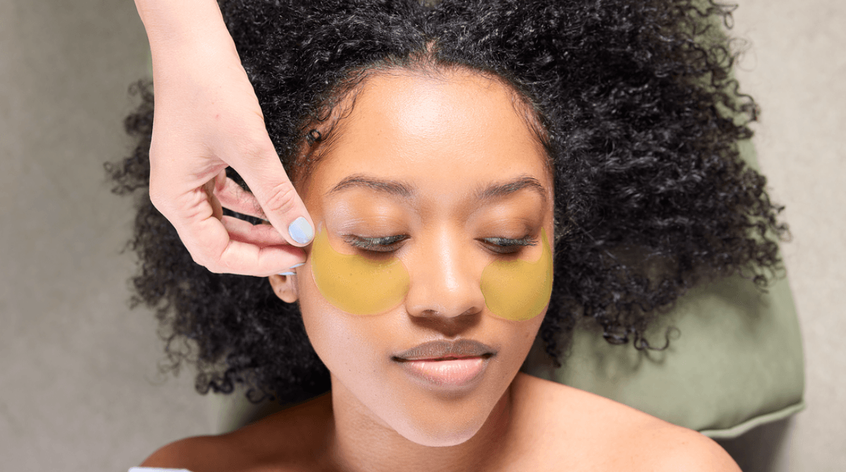 A woman receives a facial treatment at a day spa.
